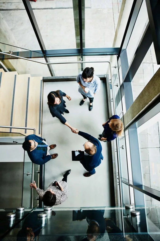 People shaking hands in stairwell