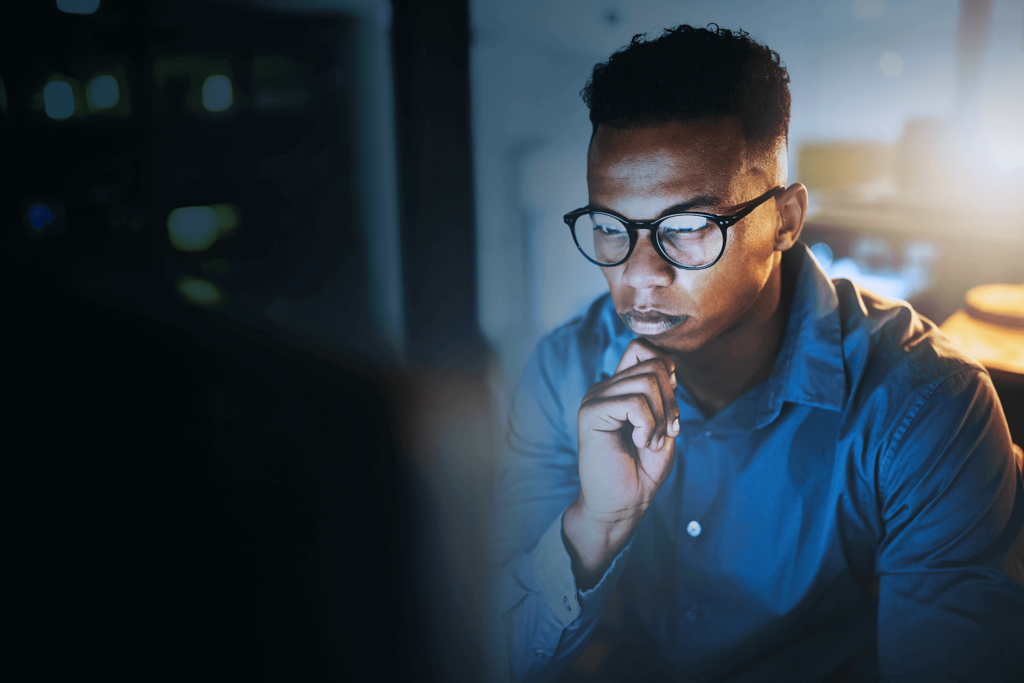 African American young man intently looking at his computer screen