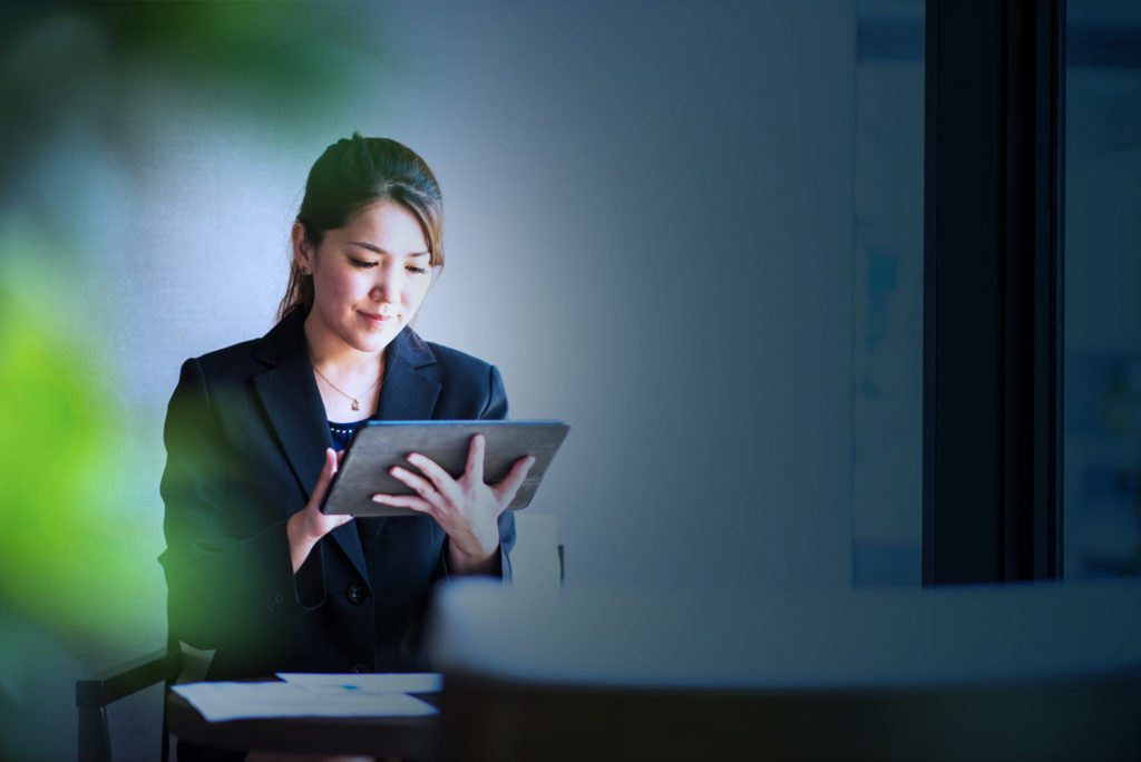 Woman looking at tablet on network secured with SASE