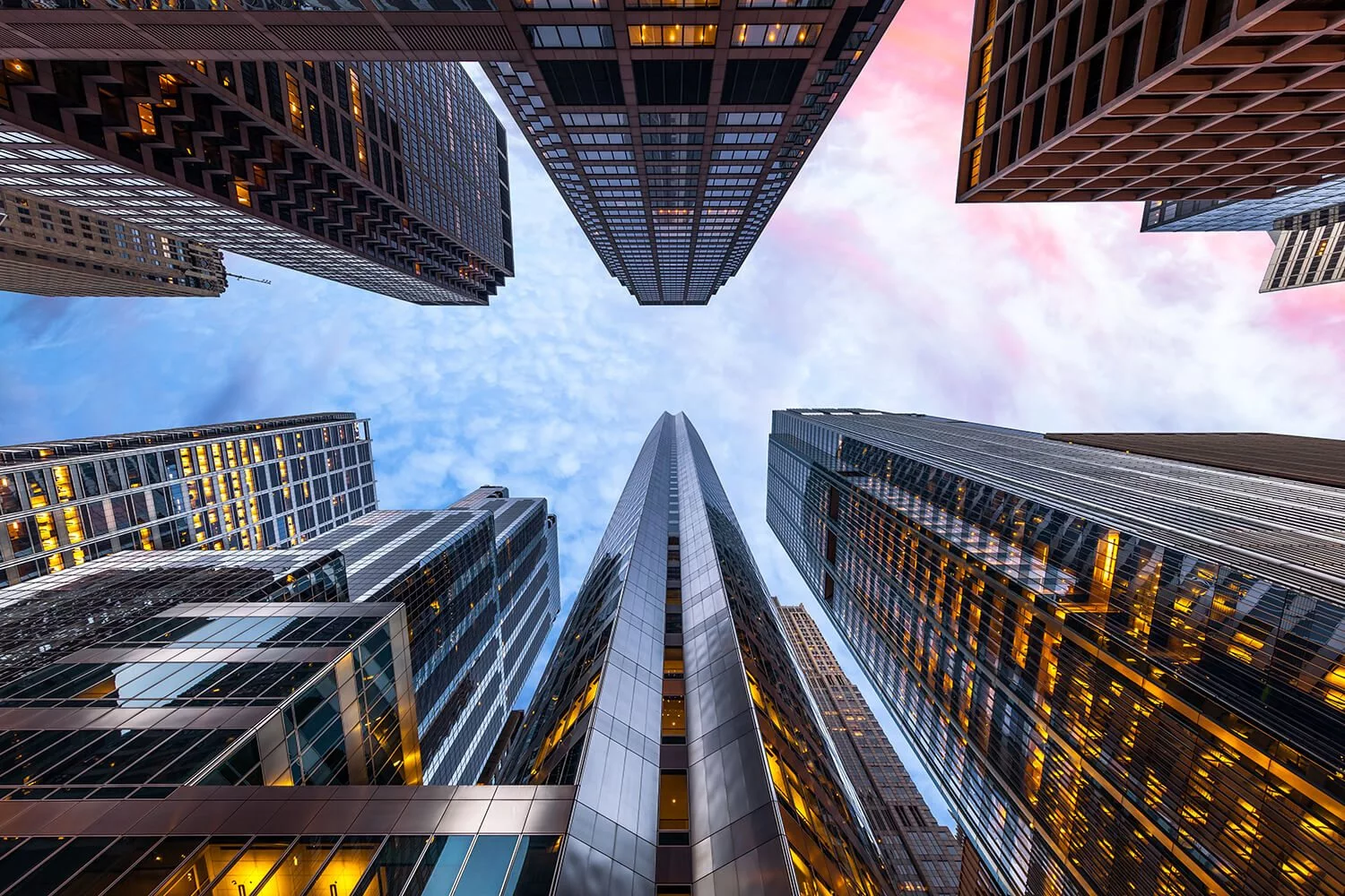 Upward view of skyline against sunset