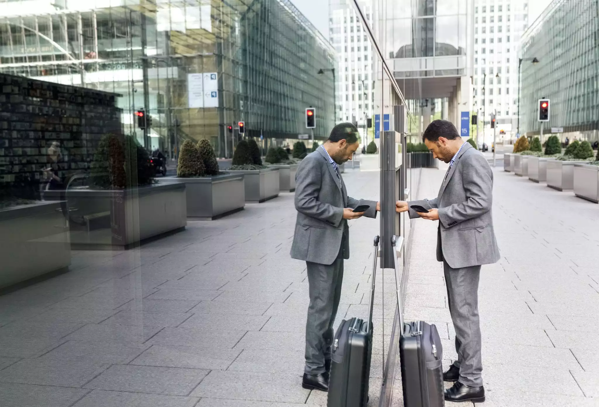 Businessman taking money at an ATM in the city